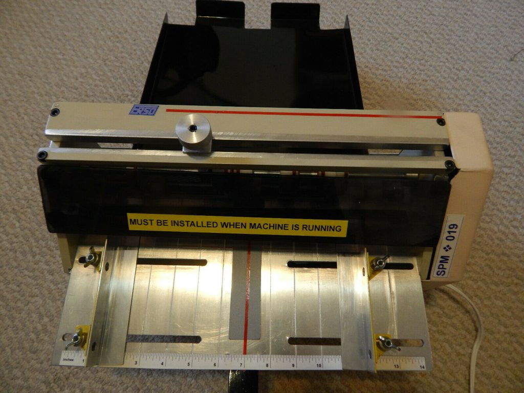 Scoring and perforating machine